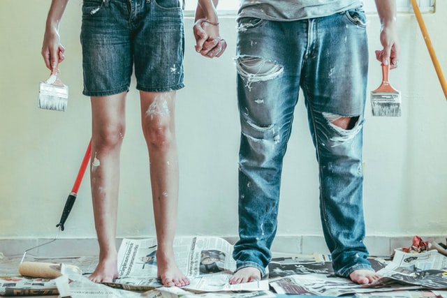 two people painting the home after renting a self-storage unit during a home renovation