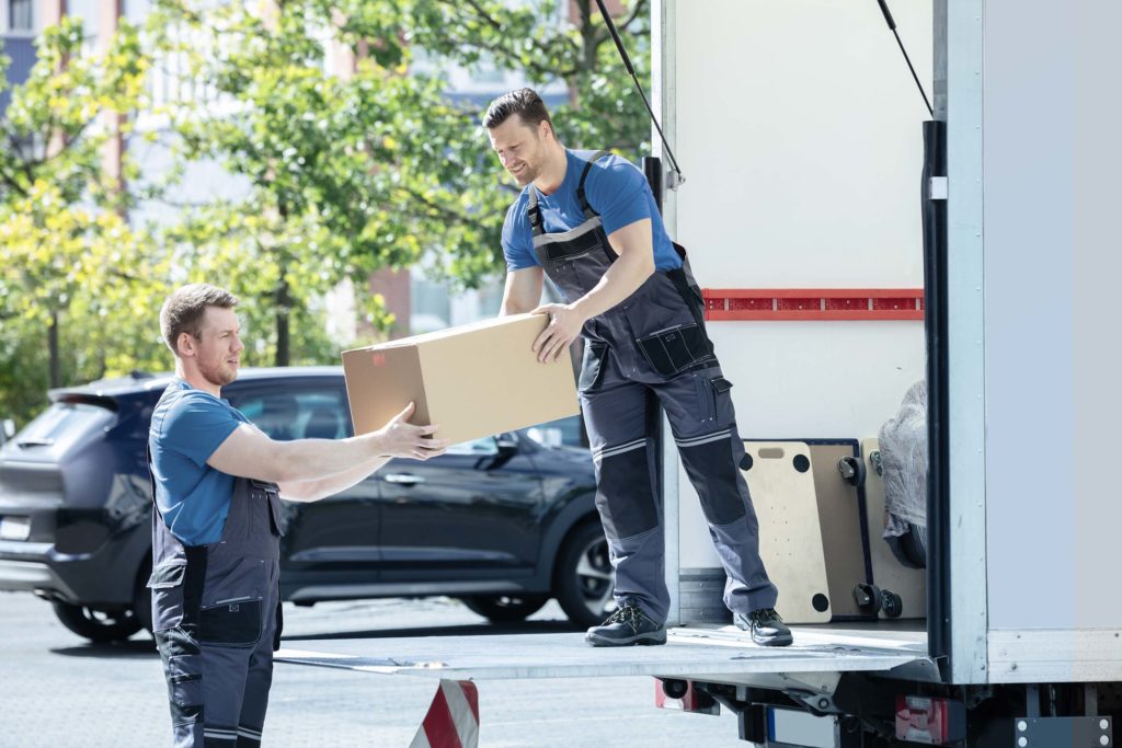 Two movers transferring a box