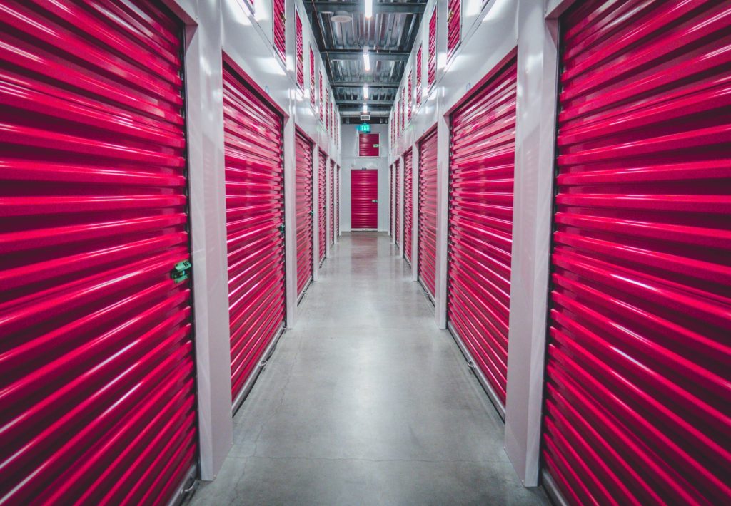 A row of storage units with red doors.